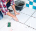 person DIY tiling bathroom floor